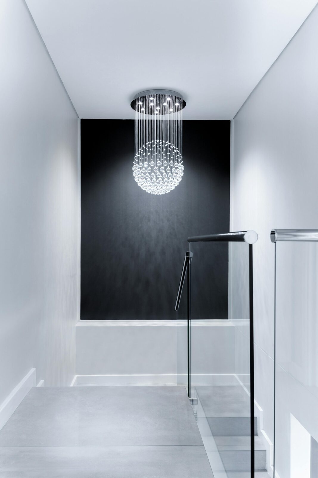 Sleek contemporary hallway featuring a stunning glass chandelier and minimalist design.